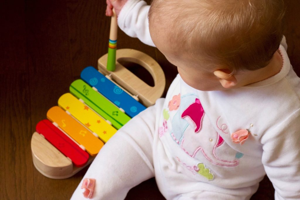 Baby playing music on xylophone