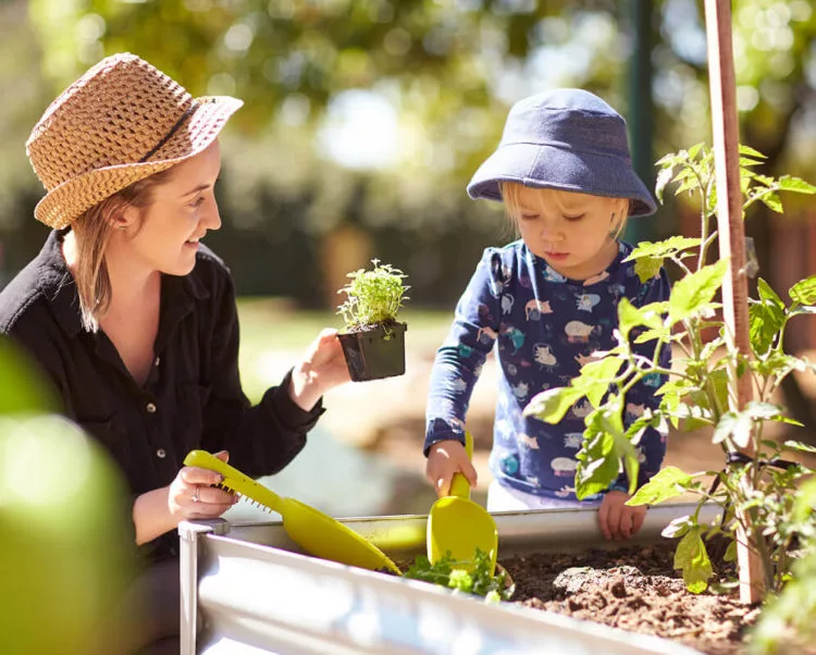 Child and educator gardening