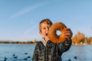 child holding a donut